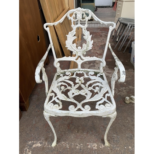 169 - A Victorian style white painted cast metal three piece patio set comprising circular table and two c... 