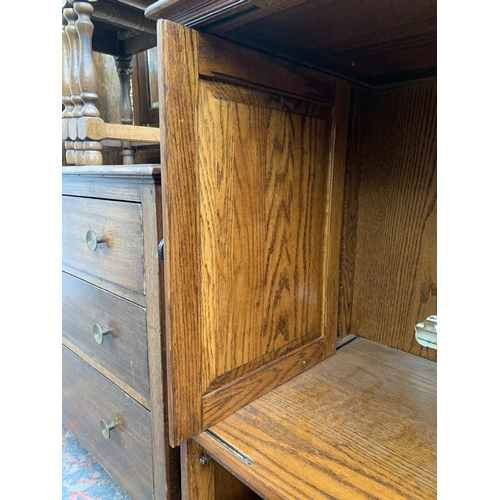 177 - A carved oak TV cabinet - approx. 104cm high x 94cm wide x 53cm deep