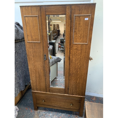 179 - An early 20th century oak mirror door wardrobe - approx. 185cm high x 95cm wide x 47cm deep