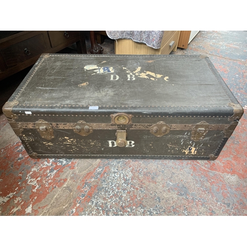 181 - An early 20th century black fibre board and brass banded travel trunk - approx. 36cm high x 106cm wi... 