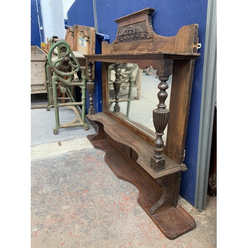 185 - A Victorian carved mahogany over mantle mirror with two brass plaques - approx. 114cm high x 120cm w... 