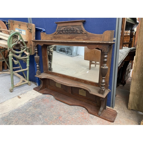 185 - A Victorian carved mahogany over mantle mirror with two brass plaques - approx. 114cm high x 120cm w... 