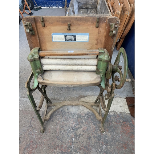 186 - An early 20th century Ewbank cast iron mangle - approx. 112cm high