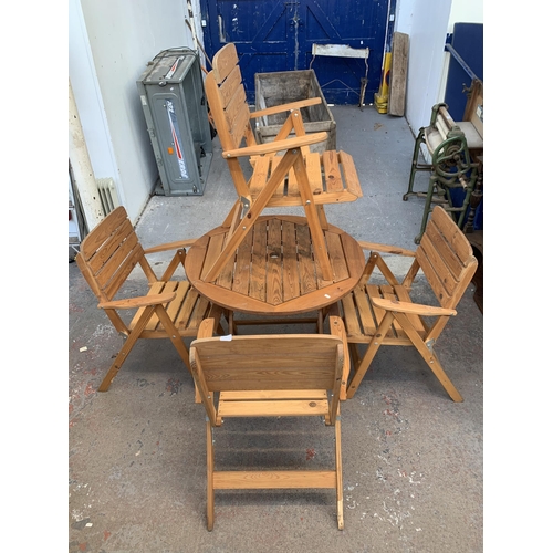 188 - A pine five piece patio set comprising circular table and four chairs - table approx. 73cm high x 91... 