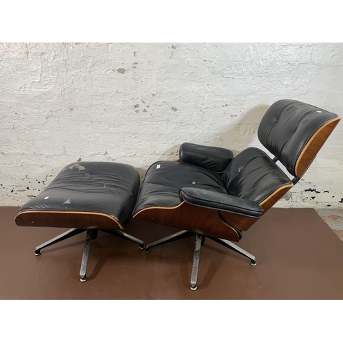 189 - A Charles & Ray Eames style black vinyl and simulated rosewood revolving lounge chair and ottoman