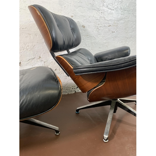 189 - A Charles & Ray Eames style black vinyl and simulated rosewood revolving lounge chair and ottoman