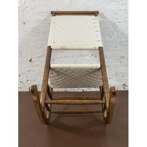 198 - An early 20th century oak and white cotton rocking chair - approx. 89cm high x 49cm wide x 65cm deep