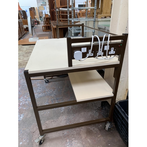 204 - A brown metal and white laminate work table on castors - approx. 88cm high x 100cm wide x 65cm deep