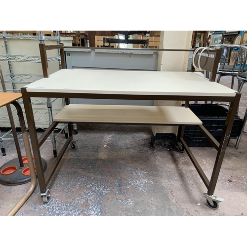 204 - A brown metal and white laminate work table on castors - approx. 88cm high x 100cm wide x 65cm deep