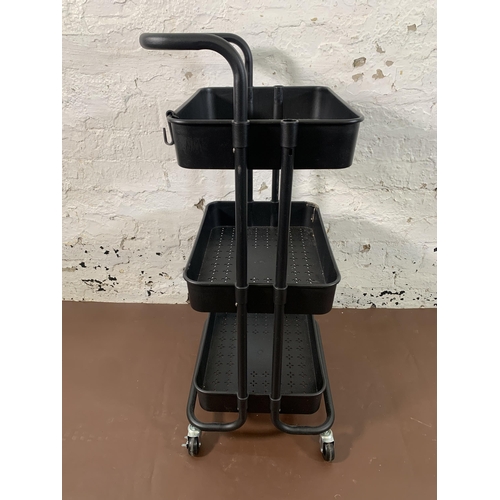 209 - A modern black metal and plastic three tier trolley - approx. 85cm high x 42cm wide x 33cm deep