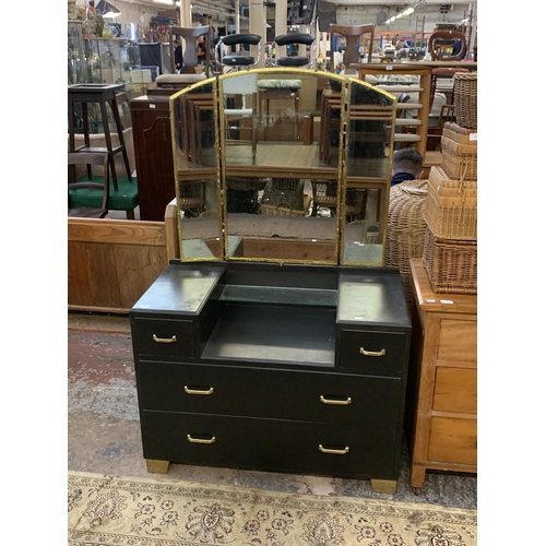 217 - A mid 20th century black painted and gilded dressing table with upper three section mirror - approx.... 