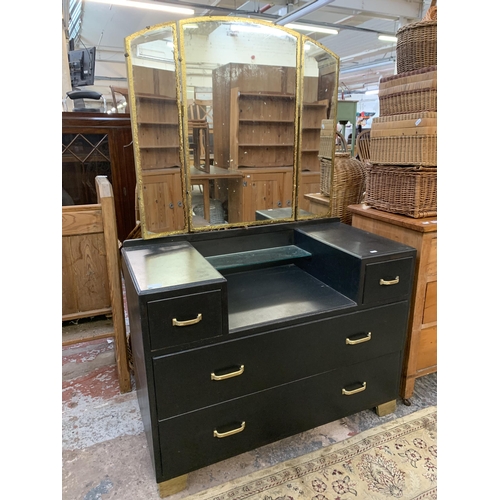 217 - A mid 20th century black painted and gilded dressing table with upper three section mirror - approx.... 