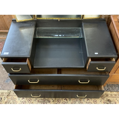 217 - A mid 20th century black painted and gilded dressing table with upper three section mirror - approx.... 