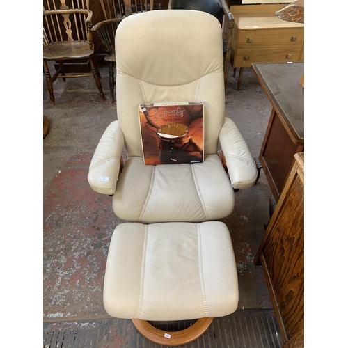 224 - An Ekornes Stressless cream leather and bentwood swivel reclining armchair and footstool with boxed ... 