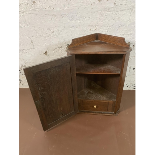 226 - An Arts & Crafts carved oak wall mountable corner cabinet - approx. 56cm high x 41cm wide x 27cm dee... 