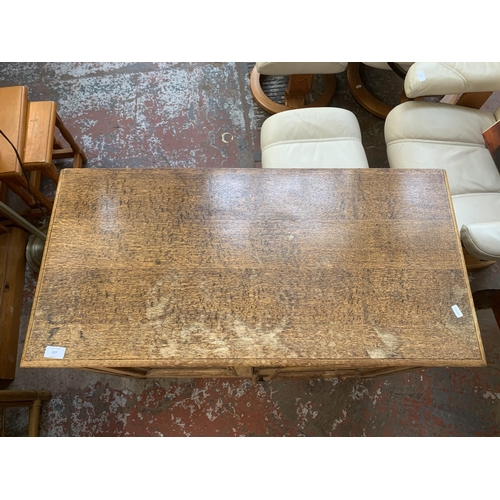 227 - A 1930s oak two door cabinet - approx. 77cm high x 93cm wide x 45cm deep