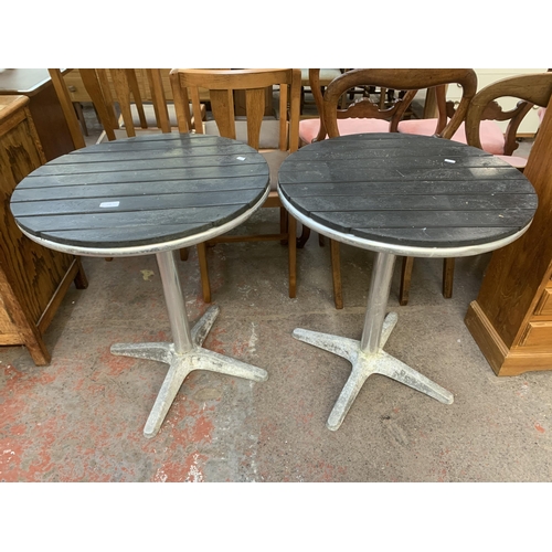 228 - A pair of metal and wooden top circular bistro tables - approx. 70cm high x 60cm diameter