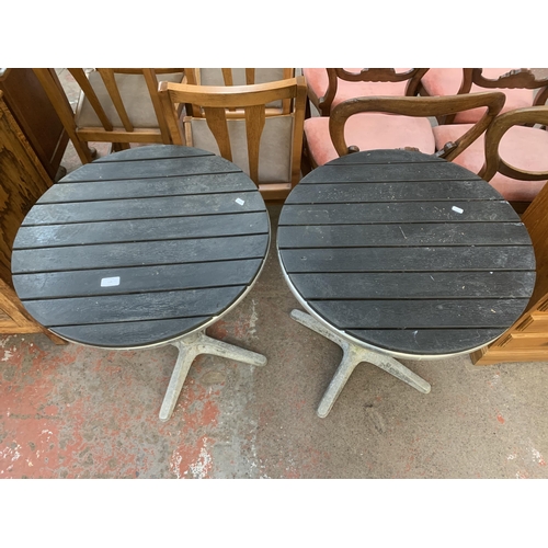 228 - A pair of metal and wooden top circular bistro tables - approx. 70cm high x 60cm diameter