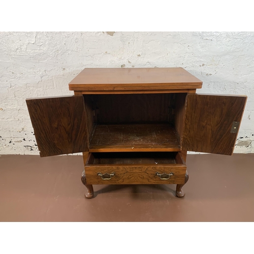 232 - A walnut two door cabinet on cabriole supports with fold over top and brown leather insert - approx.... 