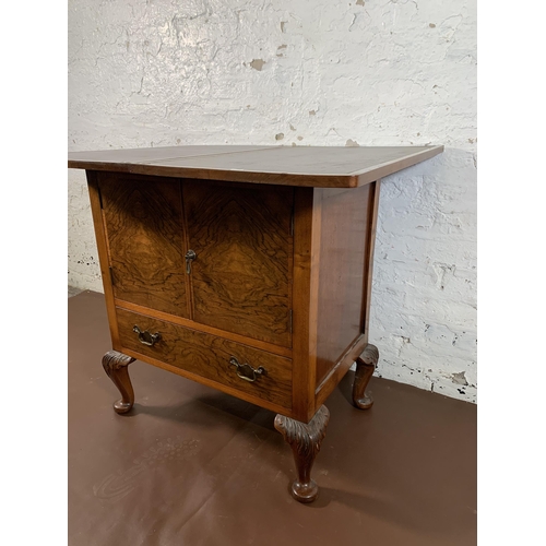 232 - A walnut two door cabinet on cabriole supports with fold over top and brown leather insert - approx.... 