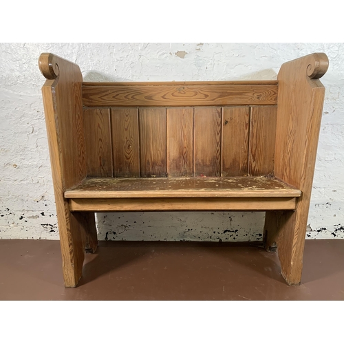 237 - A pitch pine church pew - approx. 95cm high x 102cm wide x 35cm deep