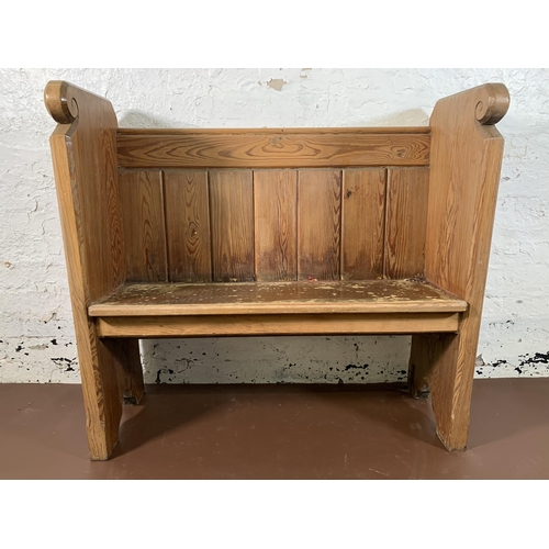 237 - A pitch pine church pew - approx. 95cm high x 102cm wide x 35cm deep