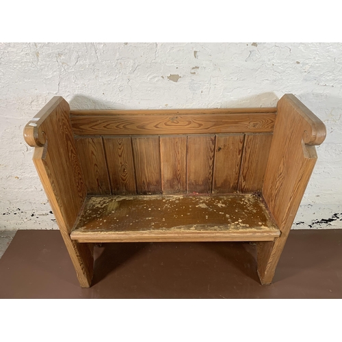 237 - A pitch pine church pew - approx. 95cm high x 102cm wide x 35cm deep