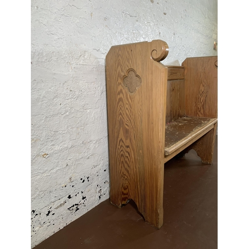 237 - A pitch pine church pew - approx. 95cm high x 102cm wide x 35cm deep