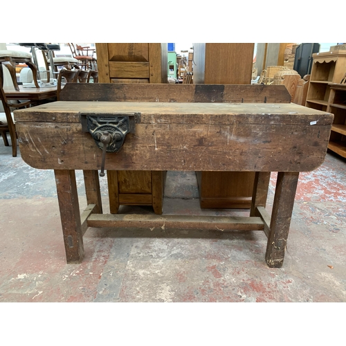 243 - An early 20th century pine workbench with fitted Record No.52 bench vice - approx. 93cm high x 136cm... 