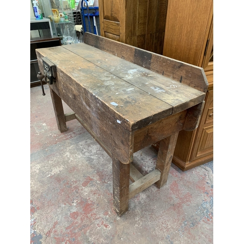 243 - An early 20th century pine workbench with fitted Record No.52 bench vice - approx. 93cm high x 136cm... 