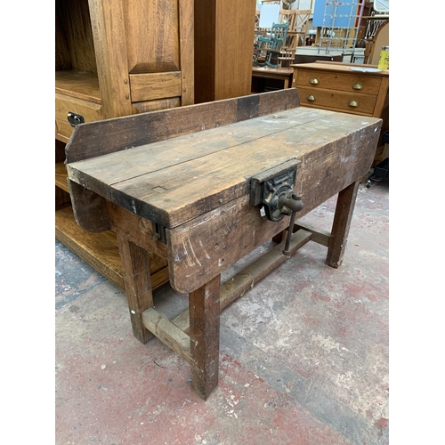 243 - An early 20th century pine workbench with fitted Record No.52 bench vice - approx. 93cm high x 136cm... 