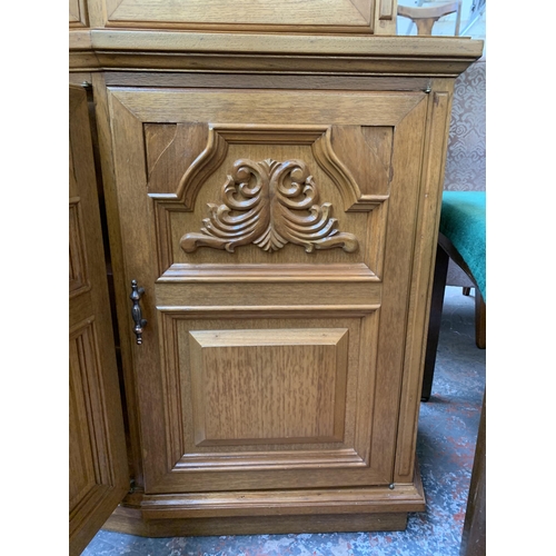 244 - A large 20th century teak display cabinet with carved floral motives - approx. 200cm high x 180cm wi... 