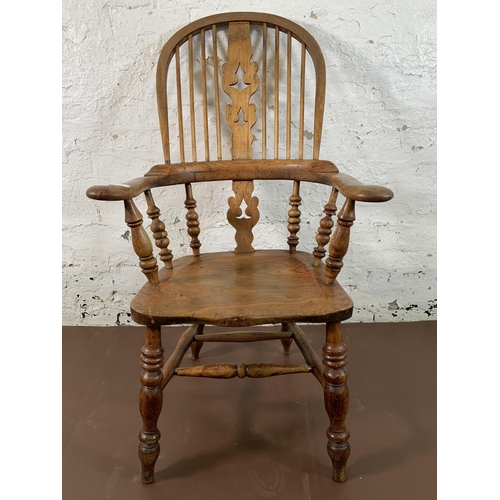 252 - A 19th century elm and beech Windsor chair with carved splat back - approx. 113cm high x 67cm wide x... 