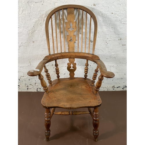 252 - A 19th century elm and beech Windsor chair with carved splat back - approx. 113cm high x 67cm wide x... 