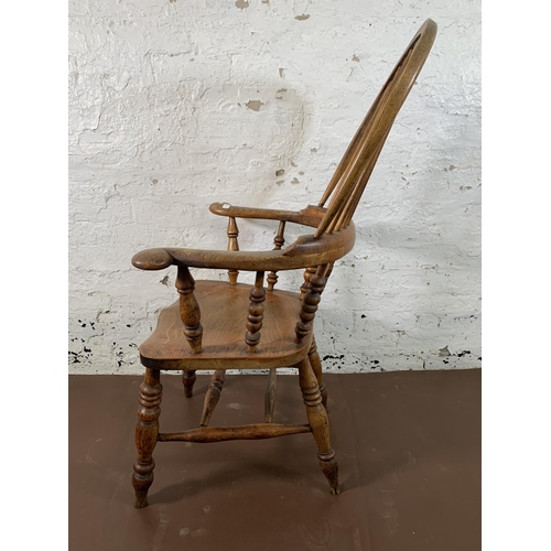 252 - A 19th century elm and beech Windsor chair with carved splat back - approx. 113cm high x 67cm wide x... 