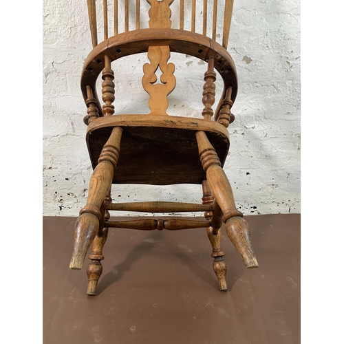 252 - A 19th century elm and beech Windsor chair with carved splat back - approx. 113cm high x 67cm wide x... 