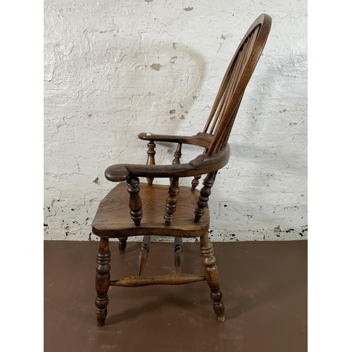 253 - A 19th century elm and beech Windsor chair with carved splat back -approx. 114cm high x 66cm wide x ... 