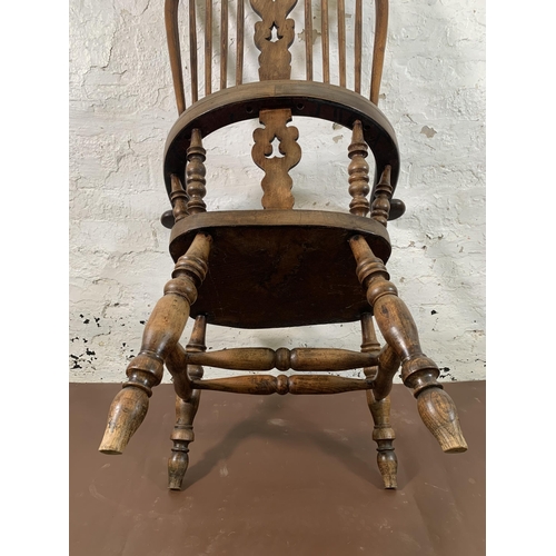 253 - A 19th century elm and beech Windsor chair with carved splat back -approx. 114cm high x 66cm wide x ... 