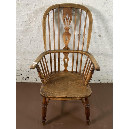 254 - A 19th century elm and beech Windsor chair with carved splat back - approx. 110cm high x 55cm wide x... 