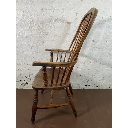 254 - A 19th century elm and beech Windsor chair with carved splat back - approx. 110cm high x 55cm wide x... 