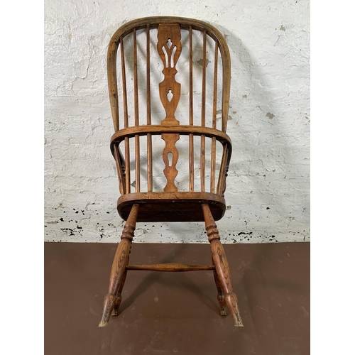 254 - A 19th century elm and beech Windsor chair with carved splat back - approx. 110cm high x 55cm wide x... 