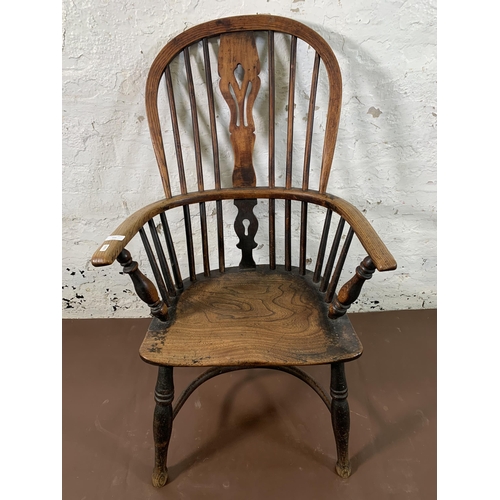 255 - A 19th century elm and beech Windsor chair with carved splat back and crinoline stretcher  - approx.... 