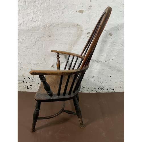 255 - A 19th century elm and beech Windsor chair with carved splat back and crinoline stretcher  - approx.... 