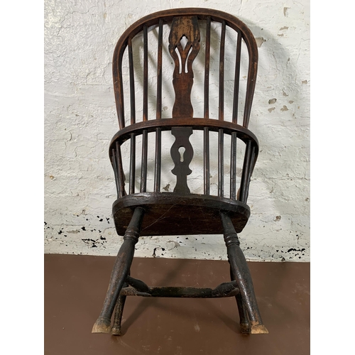 255 - A 19th century elm and beech Windsor chair with carved splat back and crinoline stretcher  - approx.... 