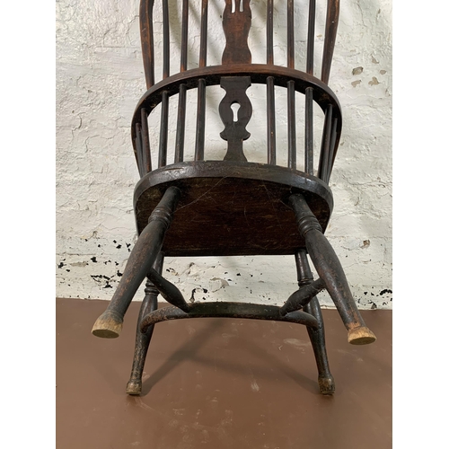 255 - A 19th century elm and beech Windsor chair with carved splat back and crinoline stretcher  - approx.... 