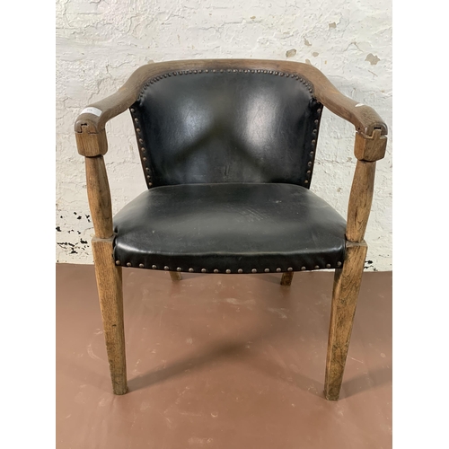 256 - An early/mid 20th century oak and black vinyl desk chair - approx. 78cm high x 55cm wide x 53cm deep