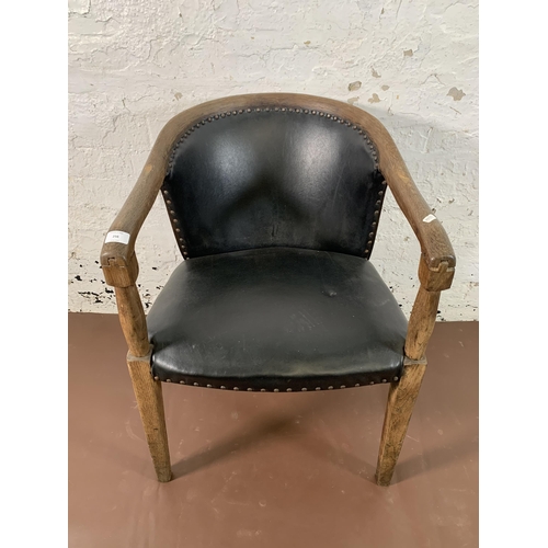 256 - An early/mid 20th century oak and black vinyl desk chair - approx. 78cm high x 55cm wide x 53cm deep