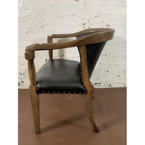 256 - An early/mid 20th century oak and black vinyl desk chair - approx. 78cm high x 55cm wide x 53cm deep