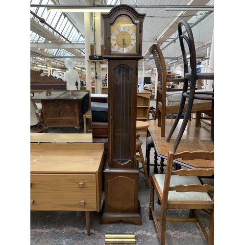 258 - A Hermle mahogany cased Grandmother clock with pendulum and weights - approx. 175cm high