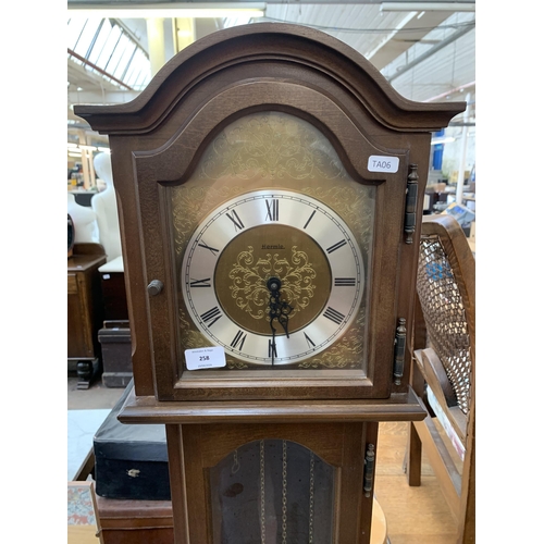 258 - A Hermle mahogany cased Grandmother clock with pendulum and weights - approx. 175cm high